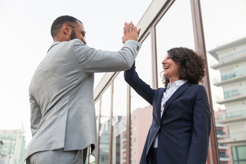 cheerful business colleagues giving high five